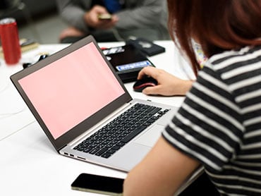 A potential employee using a laptop computer to submit a job application online.